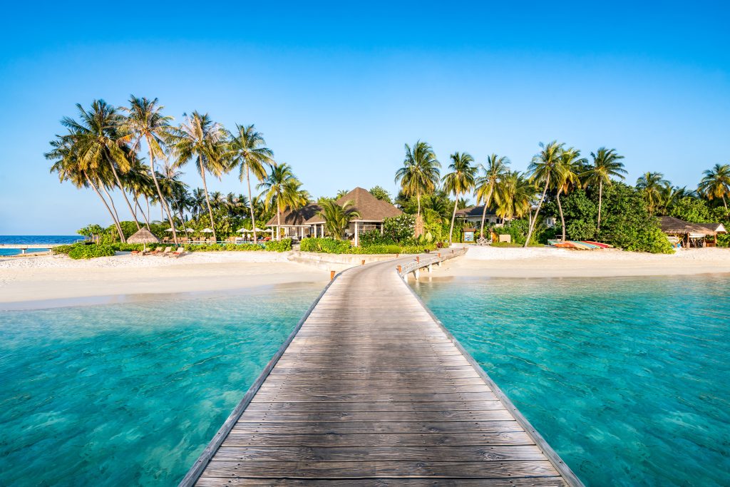 Boardwalk leading to a hut on a beach in Fiji, one of the cheapest destinations to fly to from Fiji